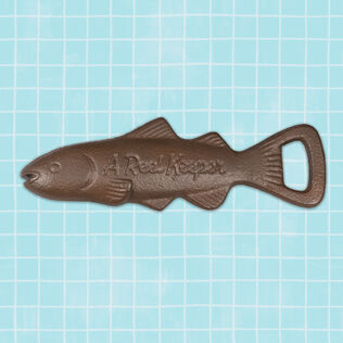 Fish-shaped metal bottle opener with “A reel catch” embossed on the side